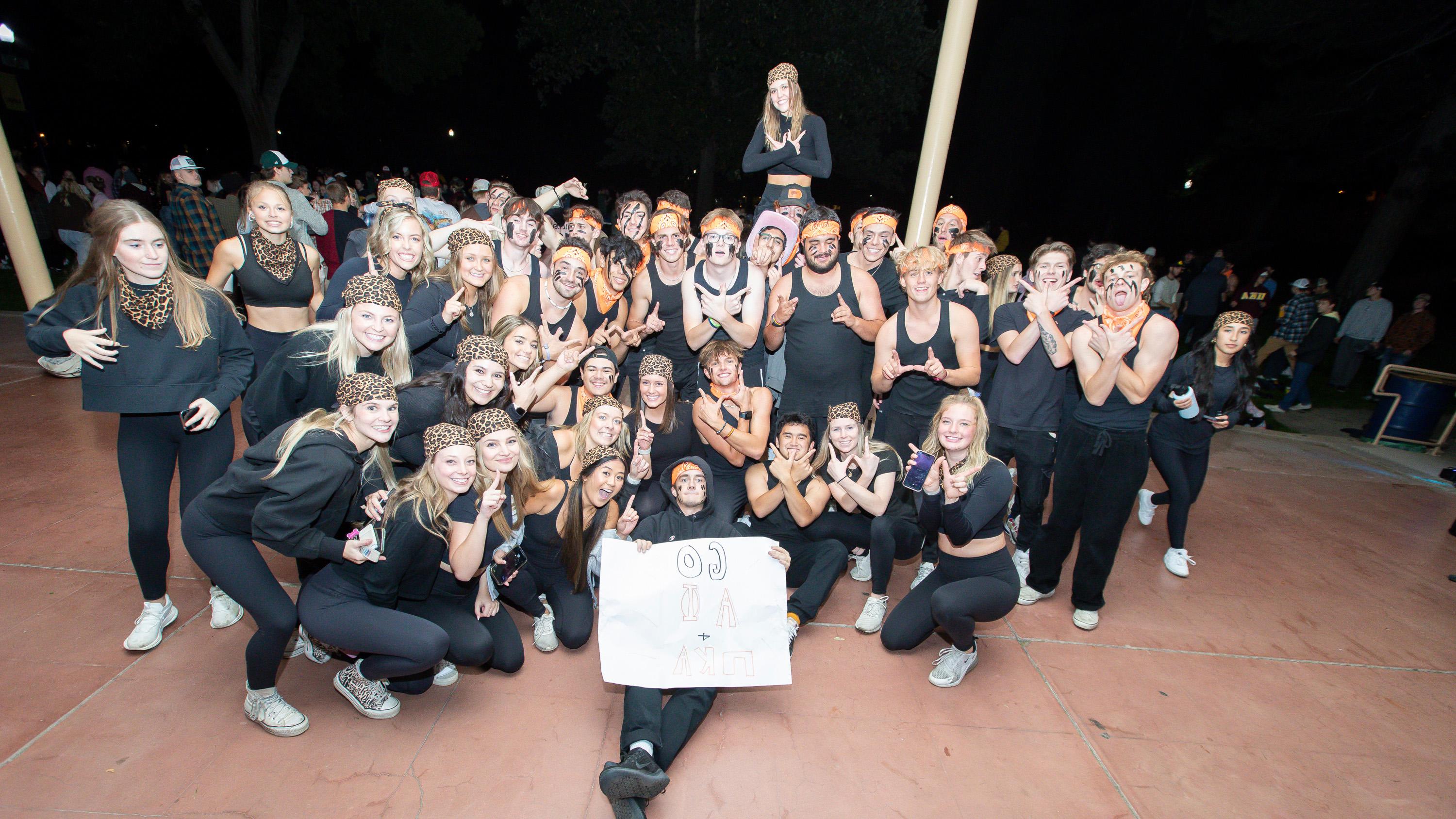 A large group of students huddled together smiling