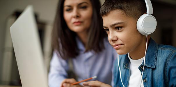 Child and parent doing remote learning, teaching